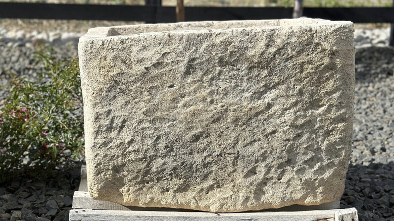 A genuine antique limestone planter outdoors