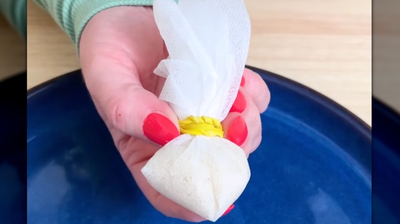 Assembled rice drawer sachet made with a dryer sheet and rubber band