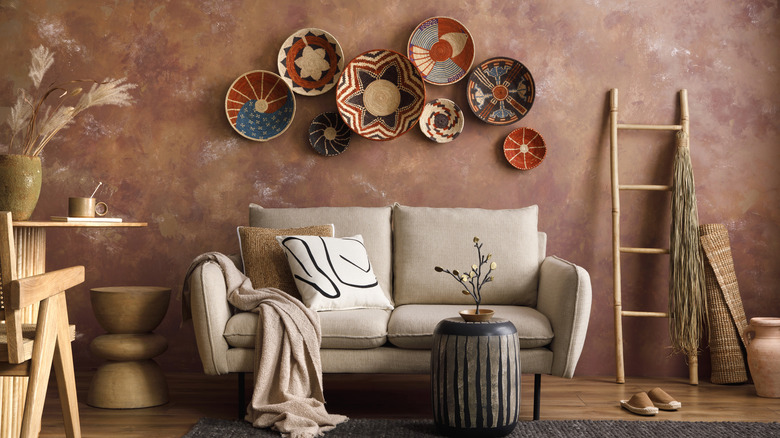patterned plates hung on wall above couch