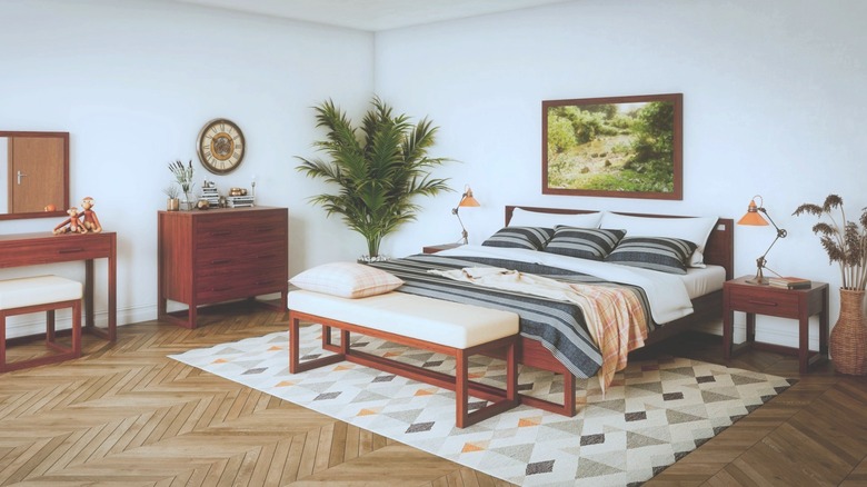 A spacious bedroom features an orange-toned oak bedsuite set.