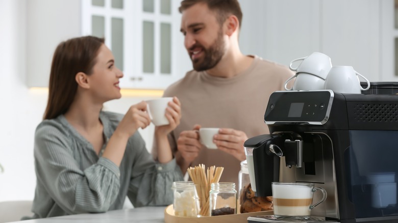 Couple drinking coffee in kitchen