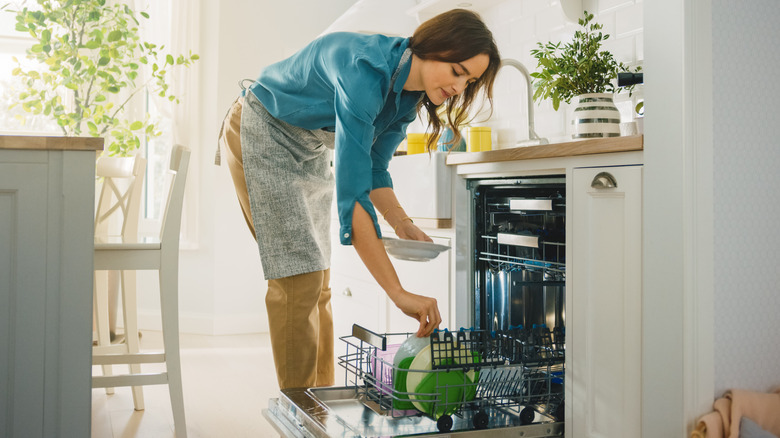 Woman loading the dishwasher