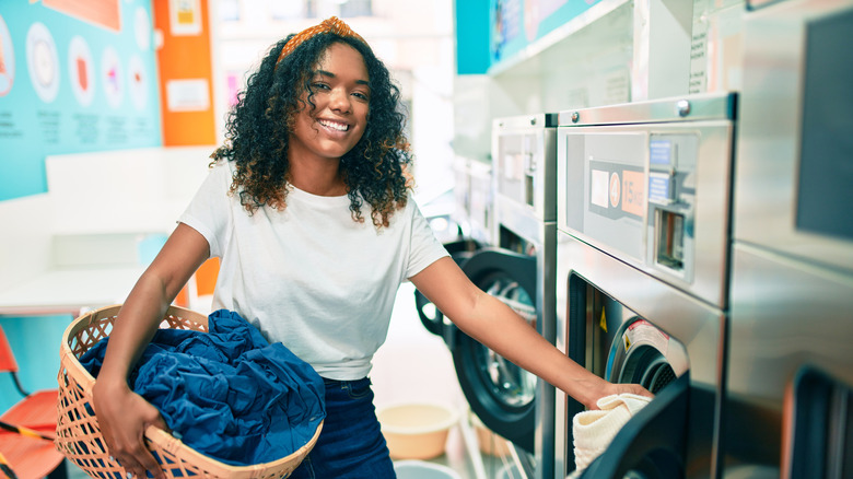 Woman smiling while doing laundry