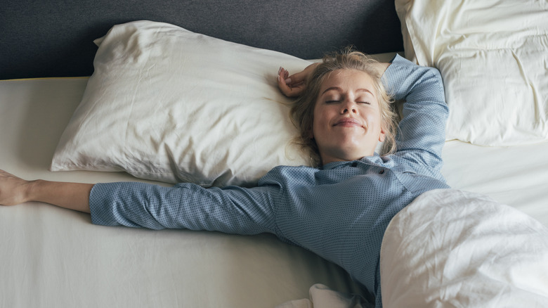 woman sleeping comfortably on bed
