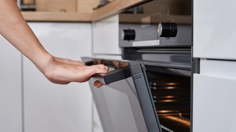 Person opening oven door