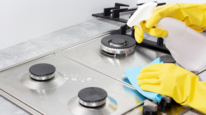 Person cleaning stovetop