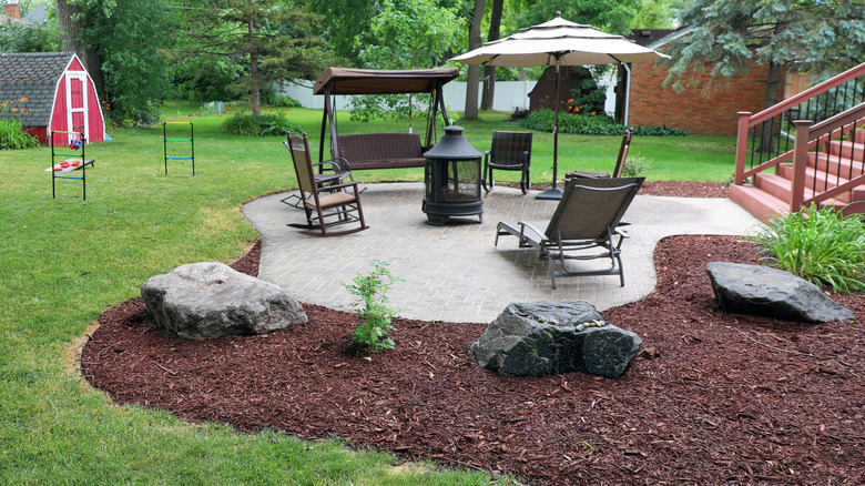 Patio surrounded by brown mulch