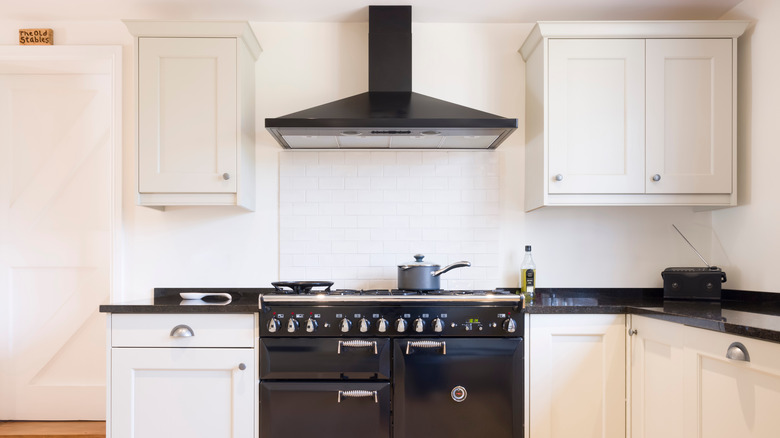 black ducted range hood in kitchen 