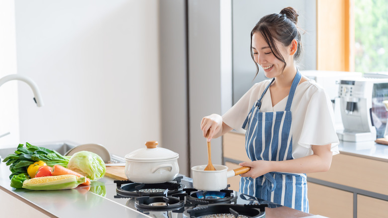 Woman cooking on stovetop