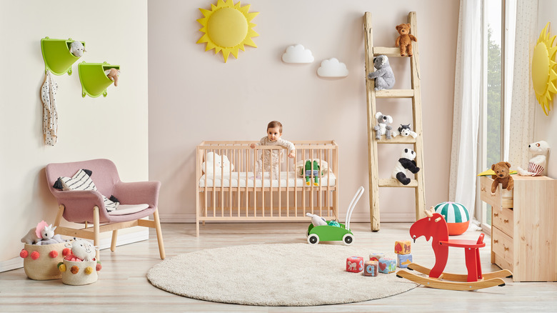 Pink wall and gray floor in baby room
