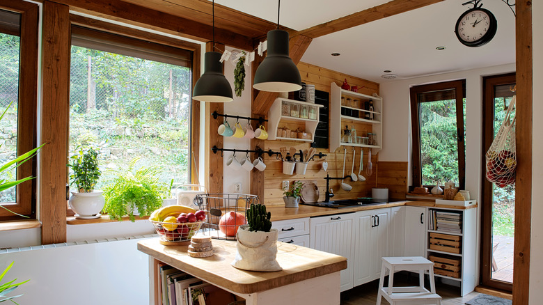 Small rustic kitchen with no upper cabinets and open shelving and hanging storage solutions