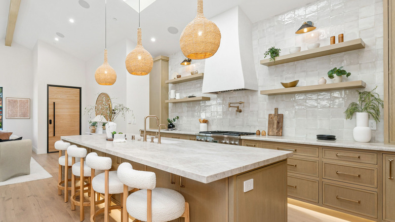 Modern white kitchen with open shelves and a range hood