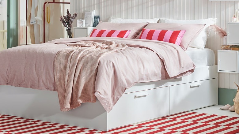 A bedroom that features IKEA's BRIMNES bed frame with internal drawers for storage
