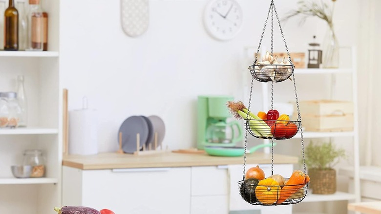 A kitchen with a three-tiered hanging basket