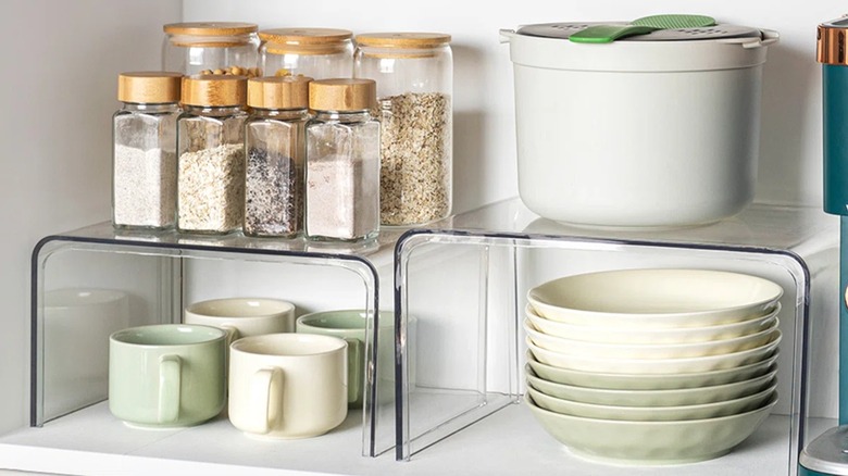 Shelf risers with spices and kitchenware