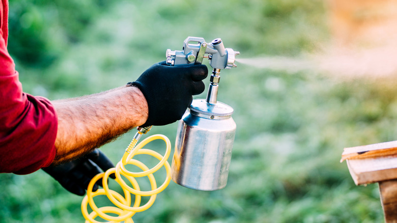 Person using paint sprayer