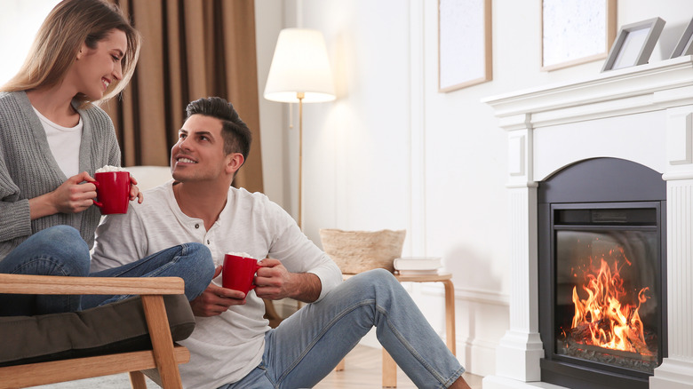 Couple by a fireplace