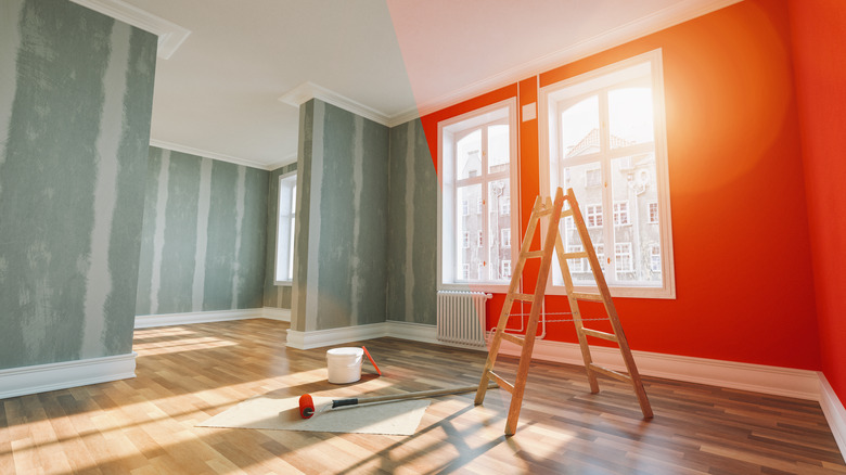 ladder paint brush and orange wall