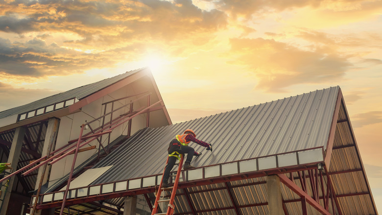 roofer installing metal roof