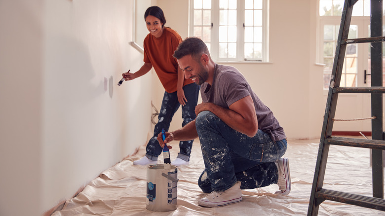 couple painting wall