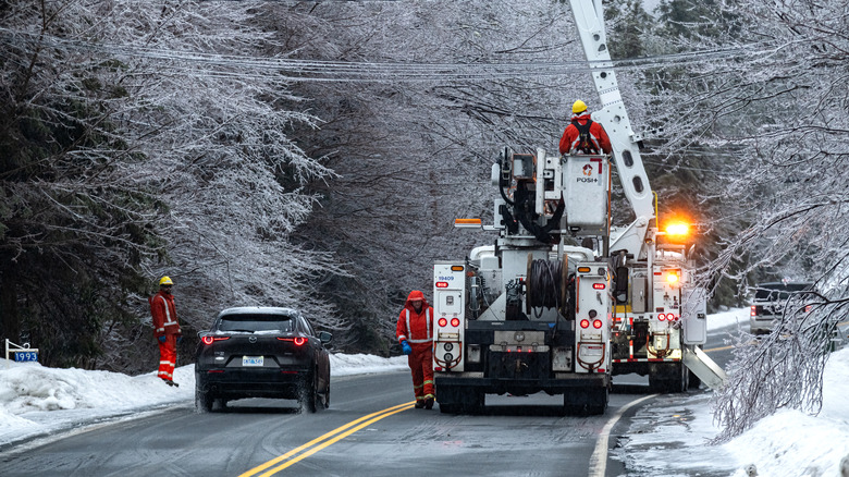 A power utility crew work to restore power after a damaging ice storm.