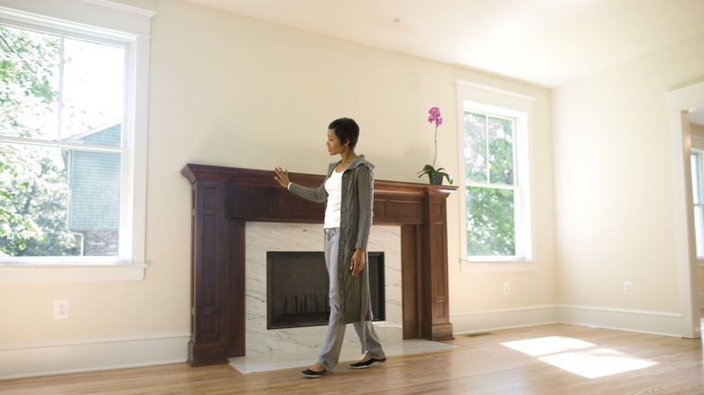 woman admiring fireplace