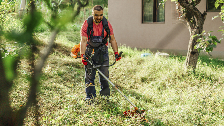 man cleaning up yard