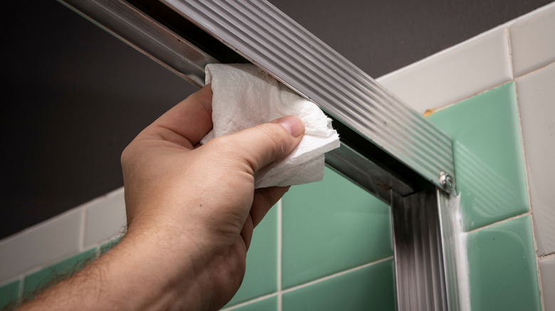 Hand wipes sliding shower door tracks