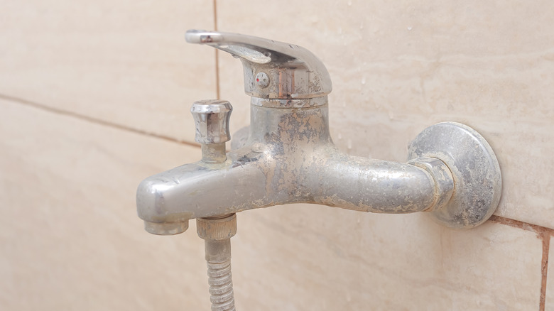 Limescale buildup on a bathtub faucet
