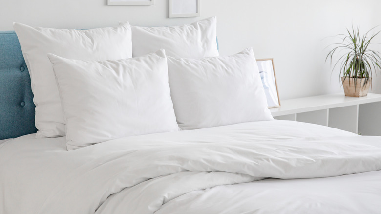 bed with bright white pillows and bedding