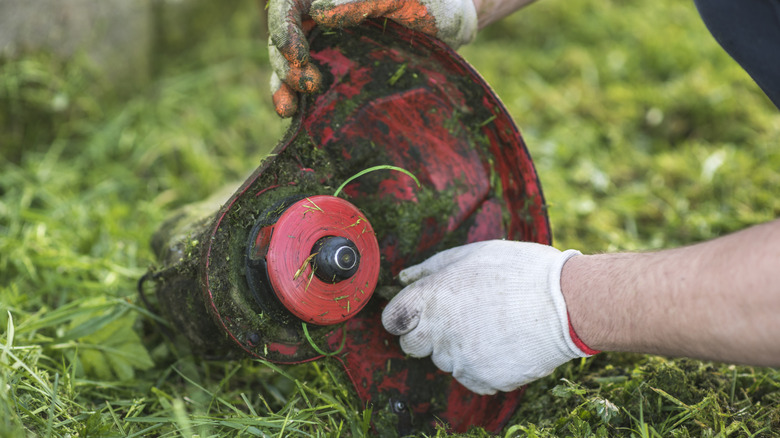 Person handling the end of a used weed wacker
