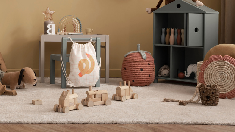 Cozy play room with wooden toys on a rug