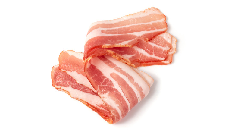 uncooked bacon on white background