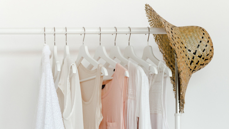 Clothing and hat on rack