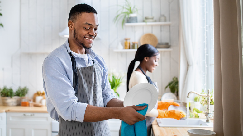 Two people washing dishes 