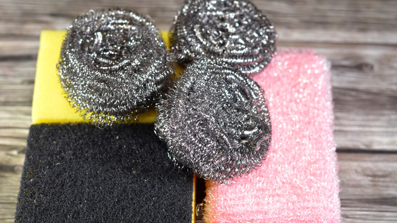 Steel wool and abrasive sponges on a surface