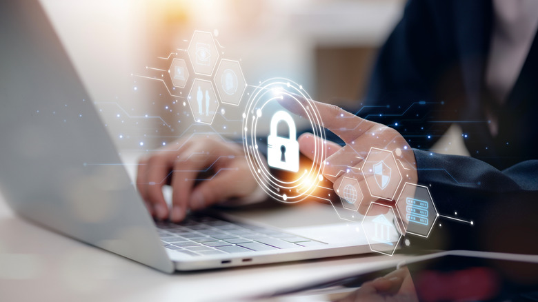 Person typing on a computer, the image of a lock superimposed on the image to evoke digital security