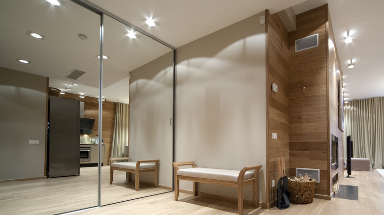 Room with a mirrored accent wall.