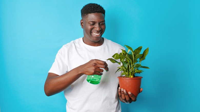 man holding plant