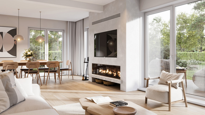 White open living space with fireplace and seating.