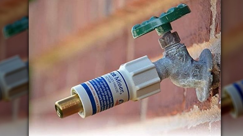 The Freeze Miser attached to an outdoor spigot on a brick building
