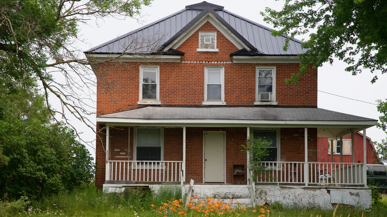 Double story brick house with white porch