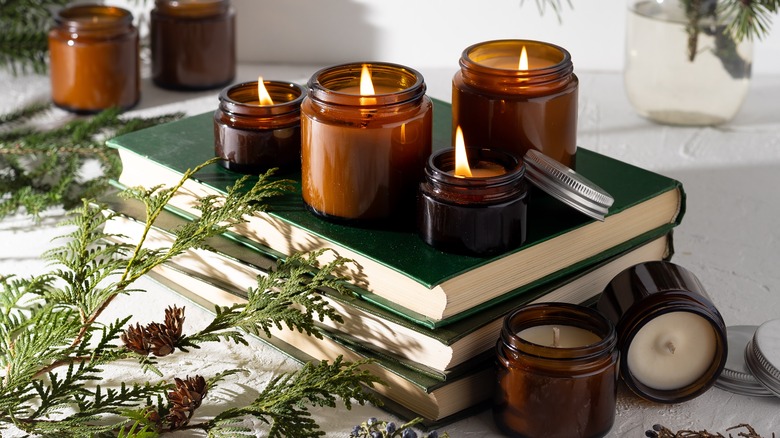 amber glass candles on books