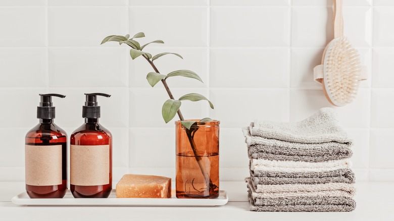 candle reused as vase in bathroom