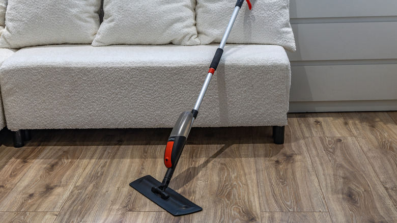 A mop on a vinyl wood-look floor