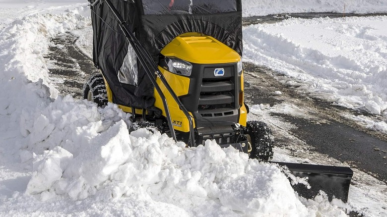 A Cub Cadet lawn tractor with a snow plow attachment