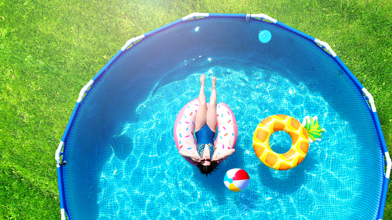 girl in pool in yard