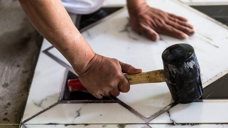 man washing tile floor