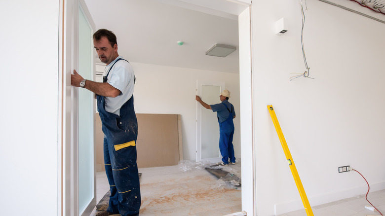 carpenter installing glass door