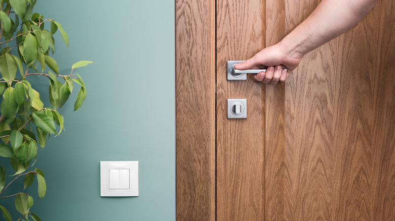 person's hand on door handle